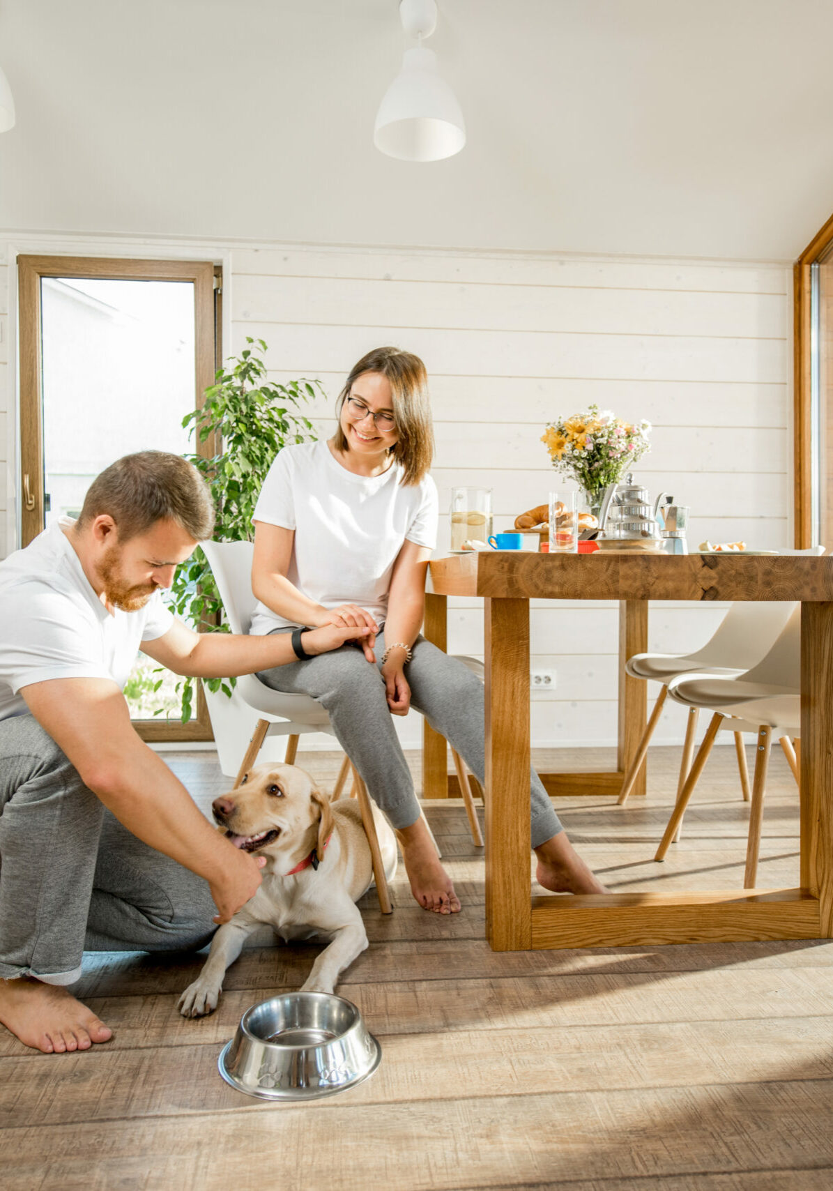 Young couple with dog at home | Floor To Ceiling Lake Design & Décor
